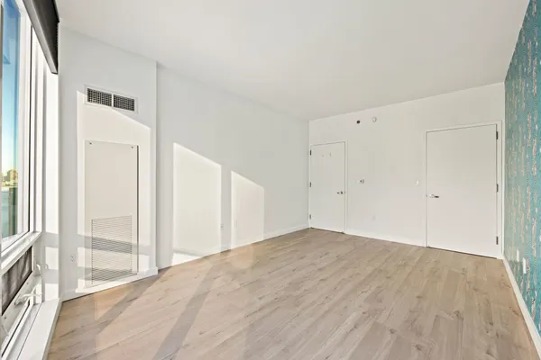 a view of a room with wooden floor
