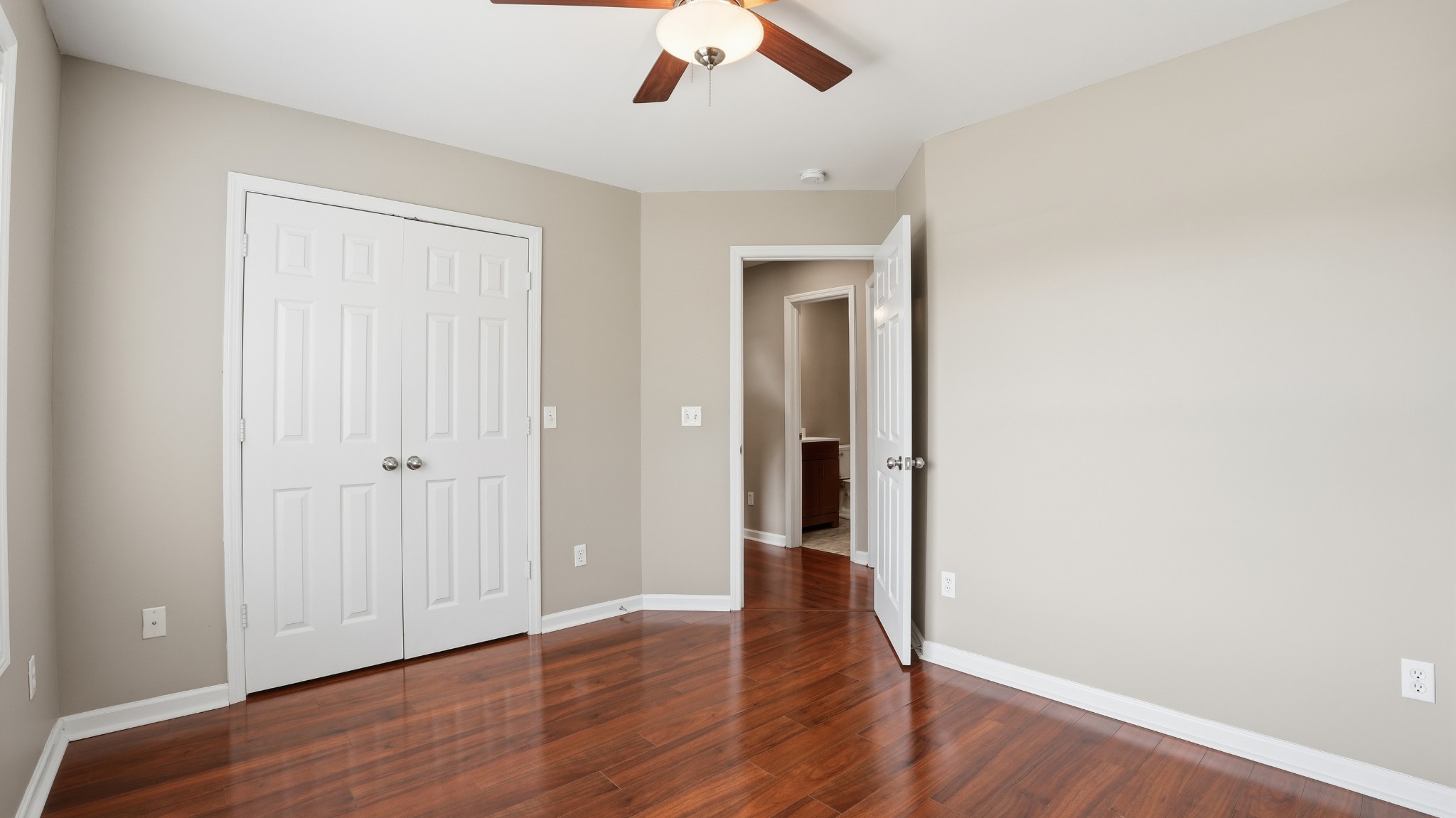 133 Riley Creek Road Tullahoma, TN 37388 - Photo 33 of 42 an empty room with wooden floor chandelier fan and windows