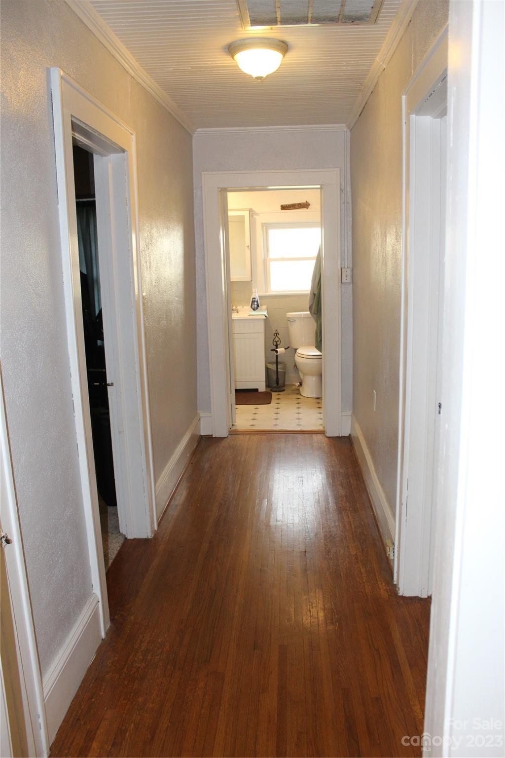 280 Bostic Yard Road Bostic, NC 28018 - Photo 20 of 34 a view of a hallway with wooden floor and a bathroom