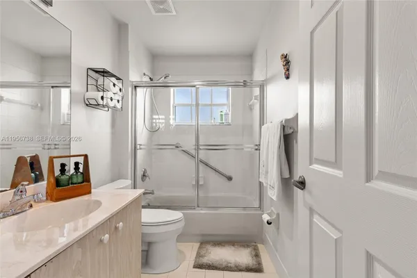 a bathroom with a toilet sink and a shower