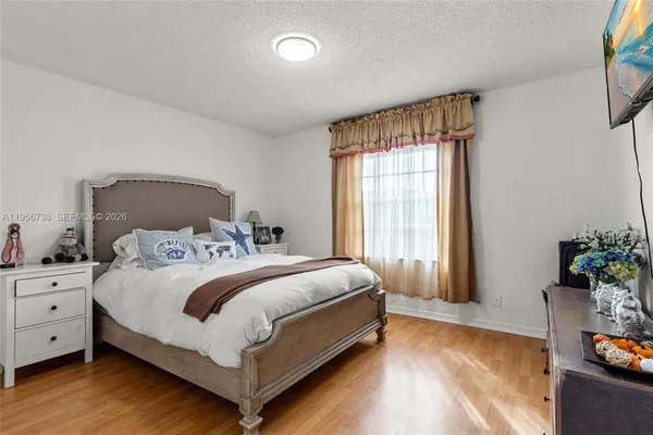 a bed sitting in a bedroom next to a window