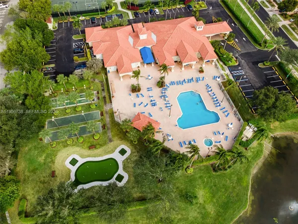 an aerial view of a house with a swimming pool and outdoor seating