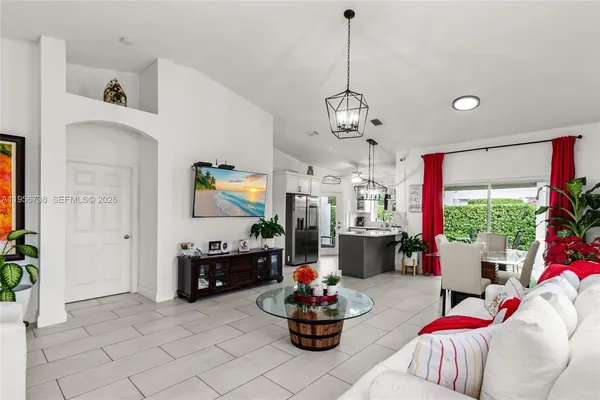 a living room with furniture and a chandelier