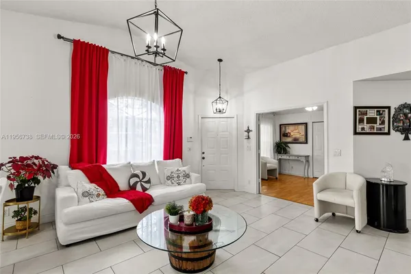 a living room with furniture and a chandelier