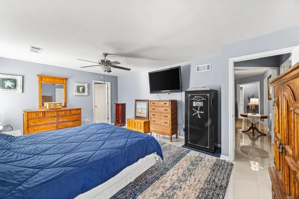 a bedroom with a bed and a television