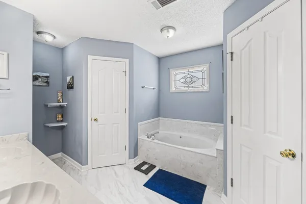 a bathroom with a tub and shower
