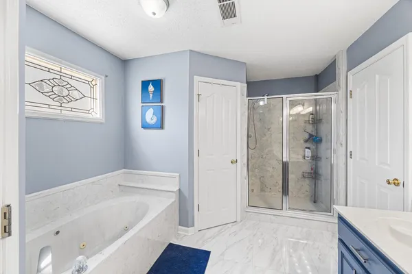 a bathroom with a bathtub and shower