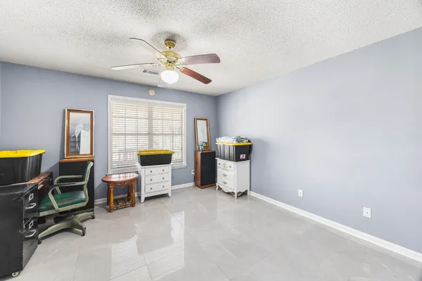 a living room with furniture a flat screen tv and a window