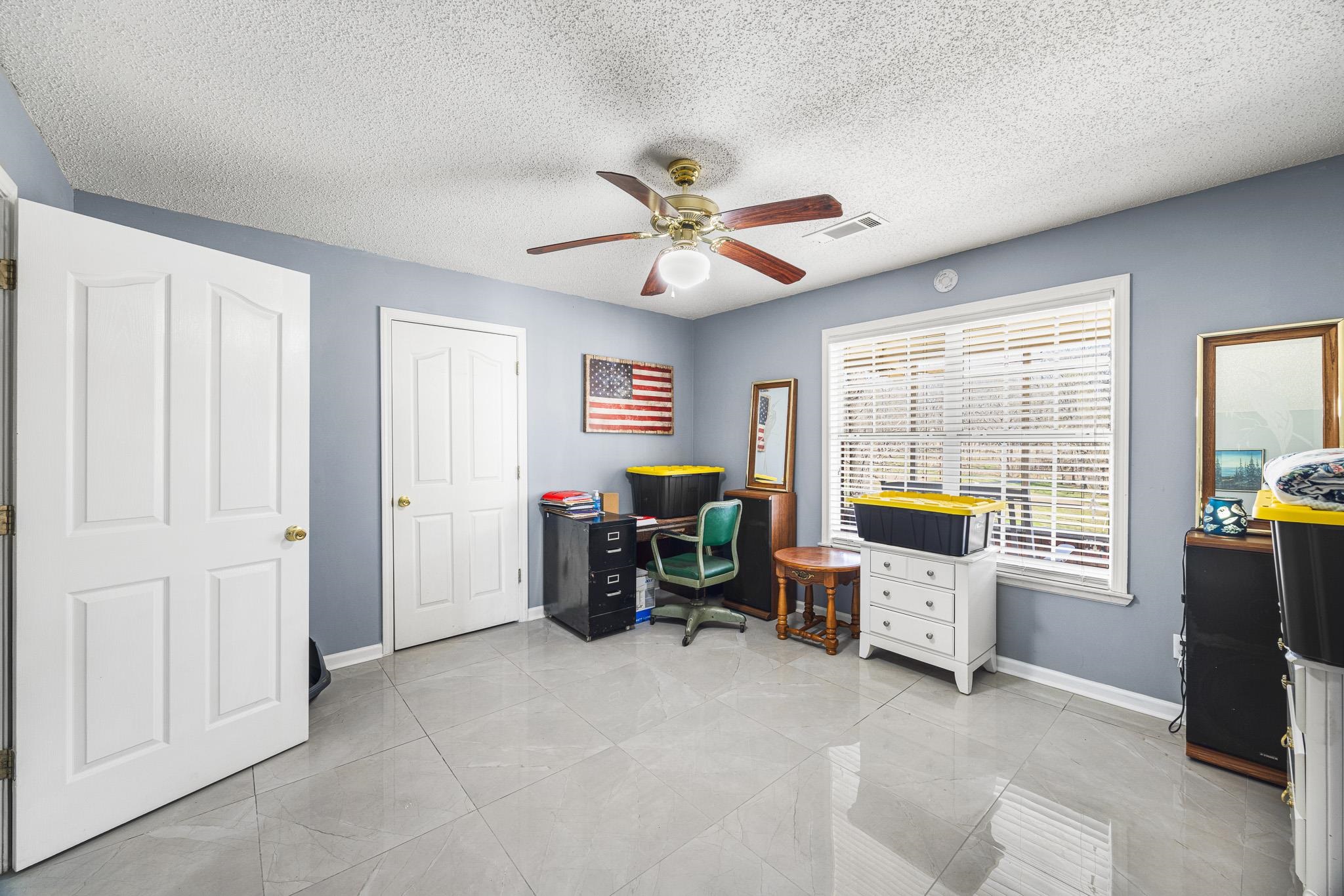 149 Abby Road Drummonds, TN 38023 - Photo 20 of 38 Bedroom with ceiling fan and a textured ceiling