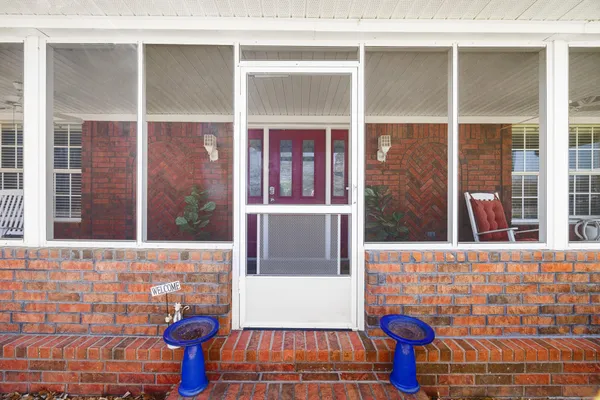 a view of a brick house with a door and a window