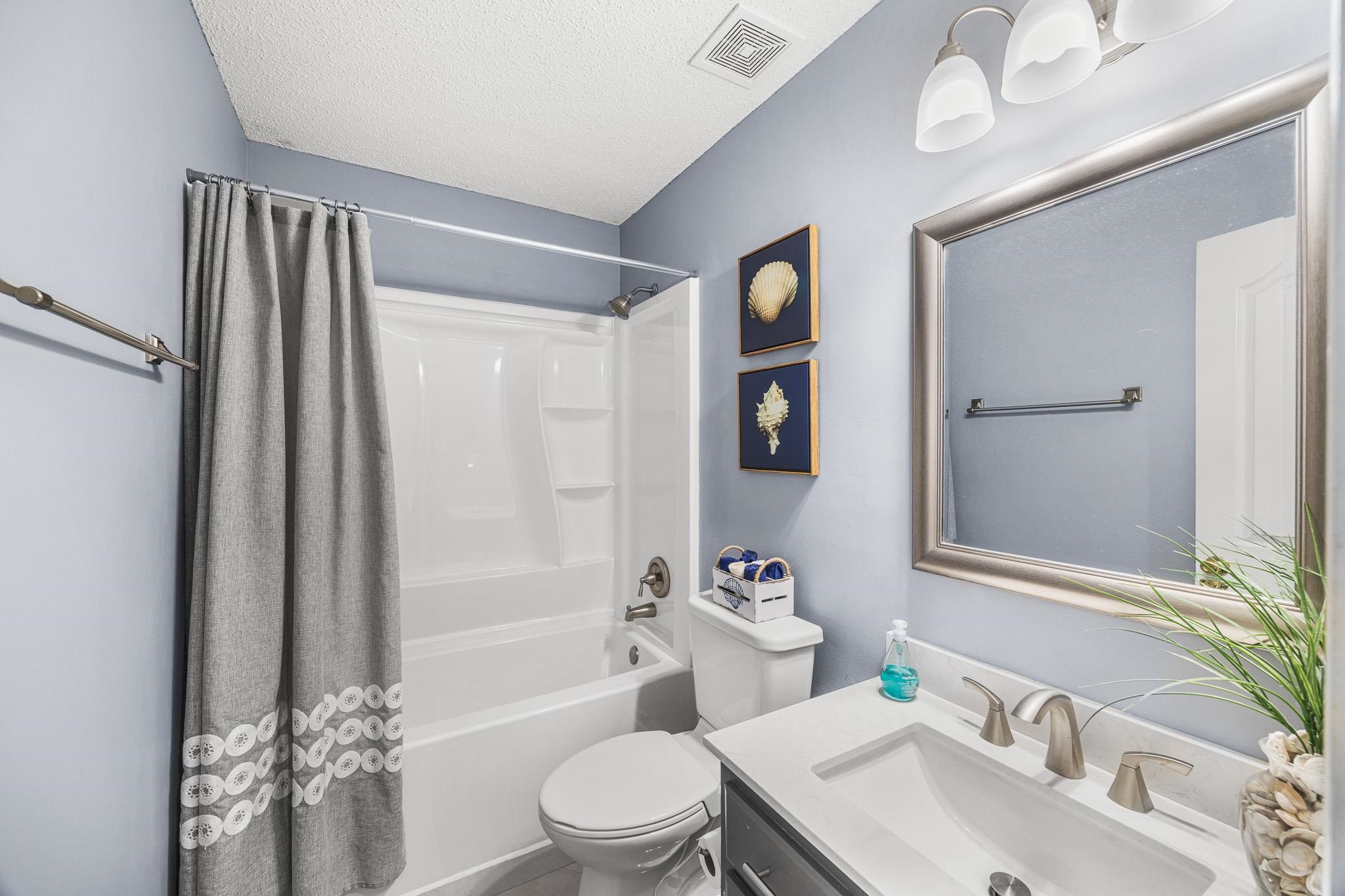 149 Abby Road Drummonds, TN 38023 - Photo 21 of 38 Full bath featuring vanity, shower / bath combination with curtain, and a textured ceiling