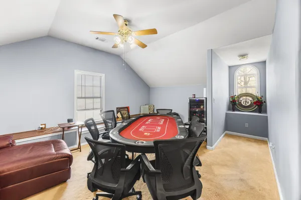 a view of a dining room with furniture and chandelier