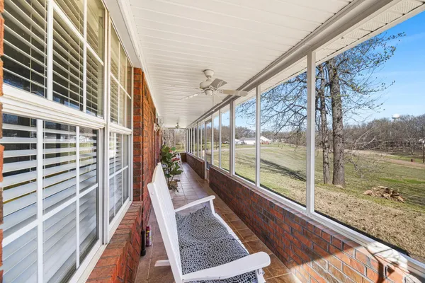 a view of balcony with a large window and wooden floor