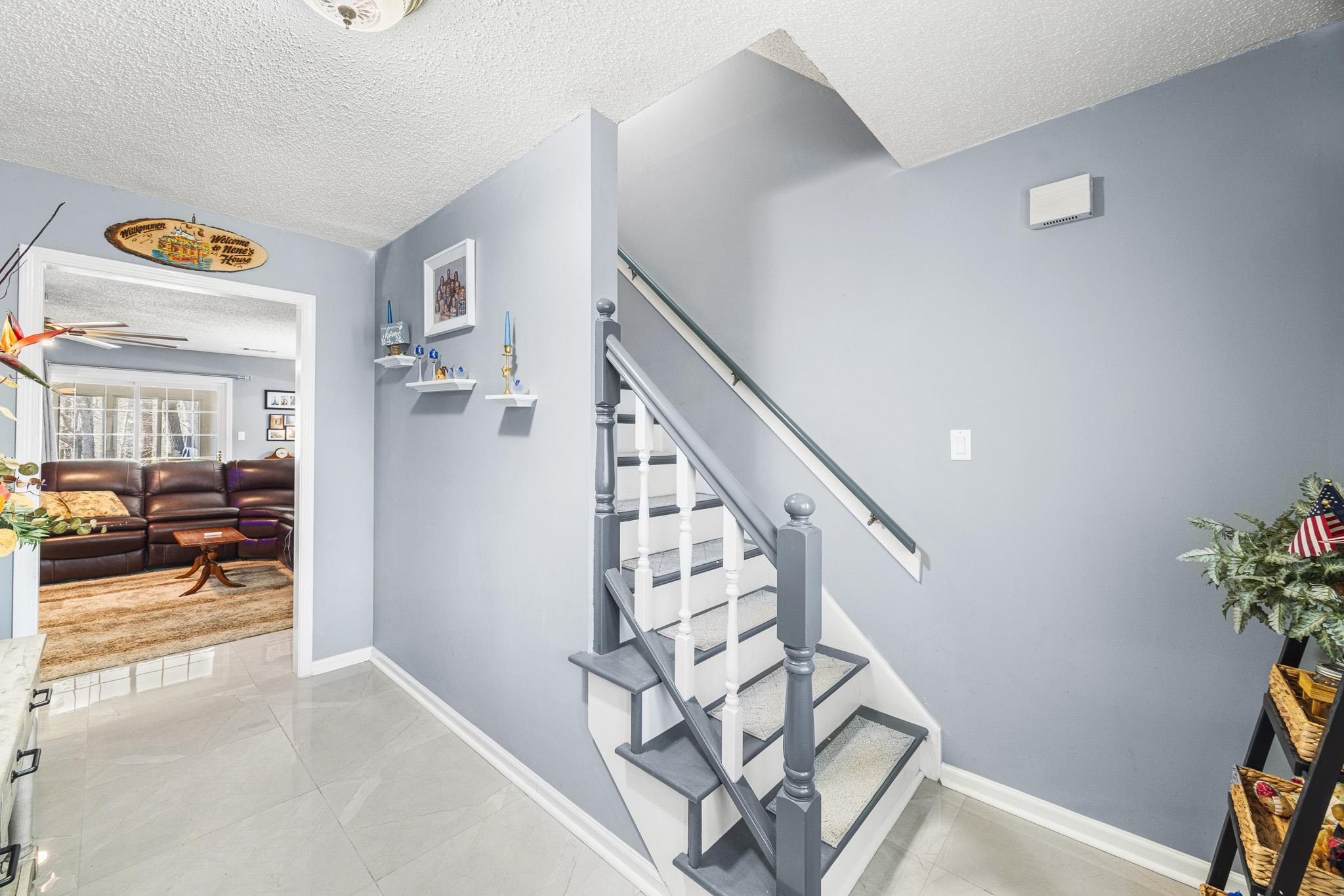 149 Abby Road Drummonds, TN 38023 - Photo 5 of 38 Staircase with a textured ceiling and a ceiling fan