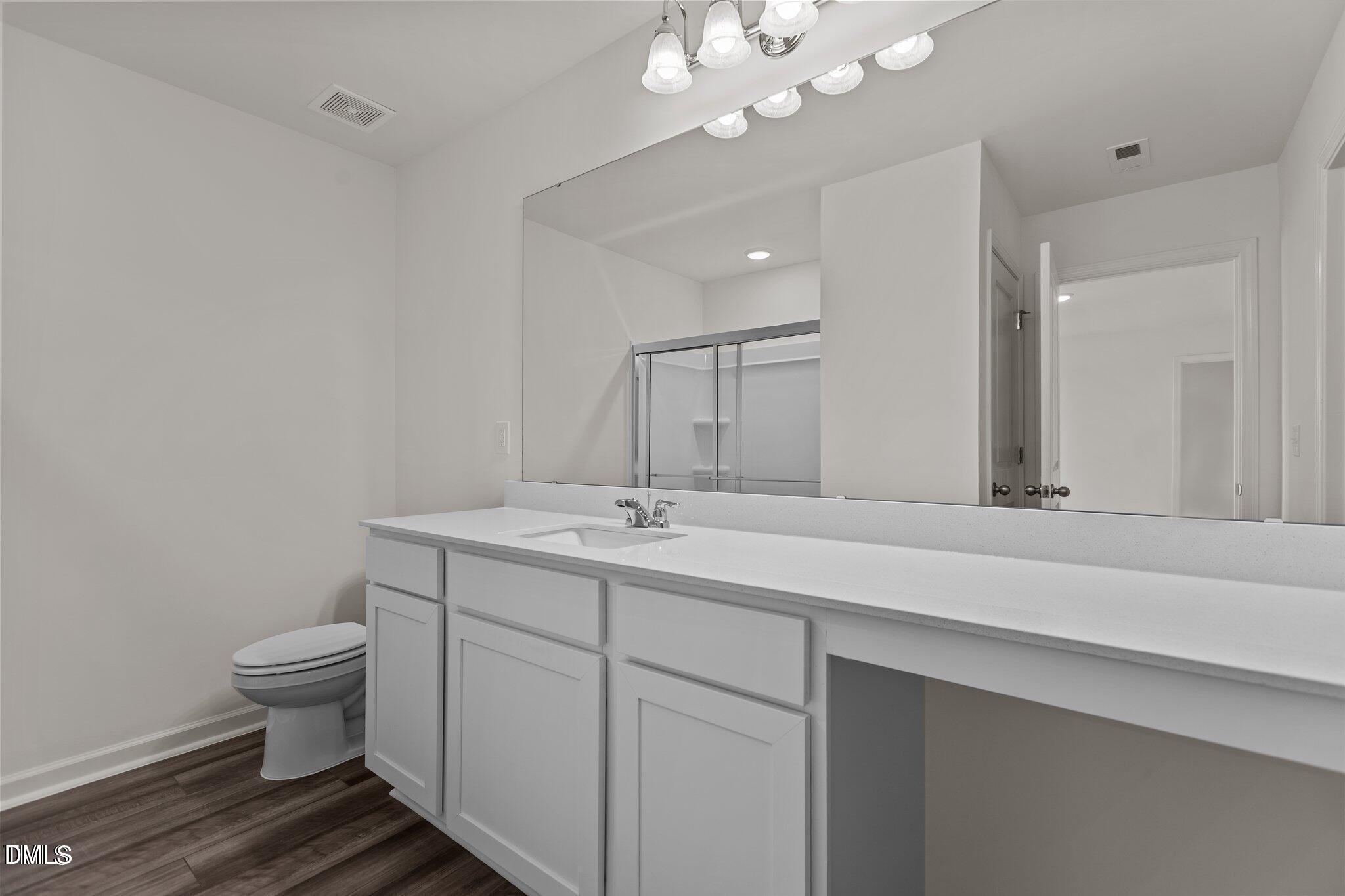 149 Bedstone Way Clayton, NC 27520 - Photo 11 of 22 a bathroom with a sink a toilet and a mirror