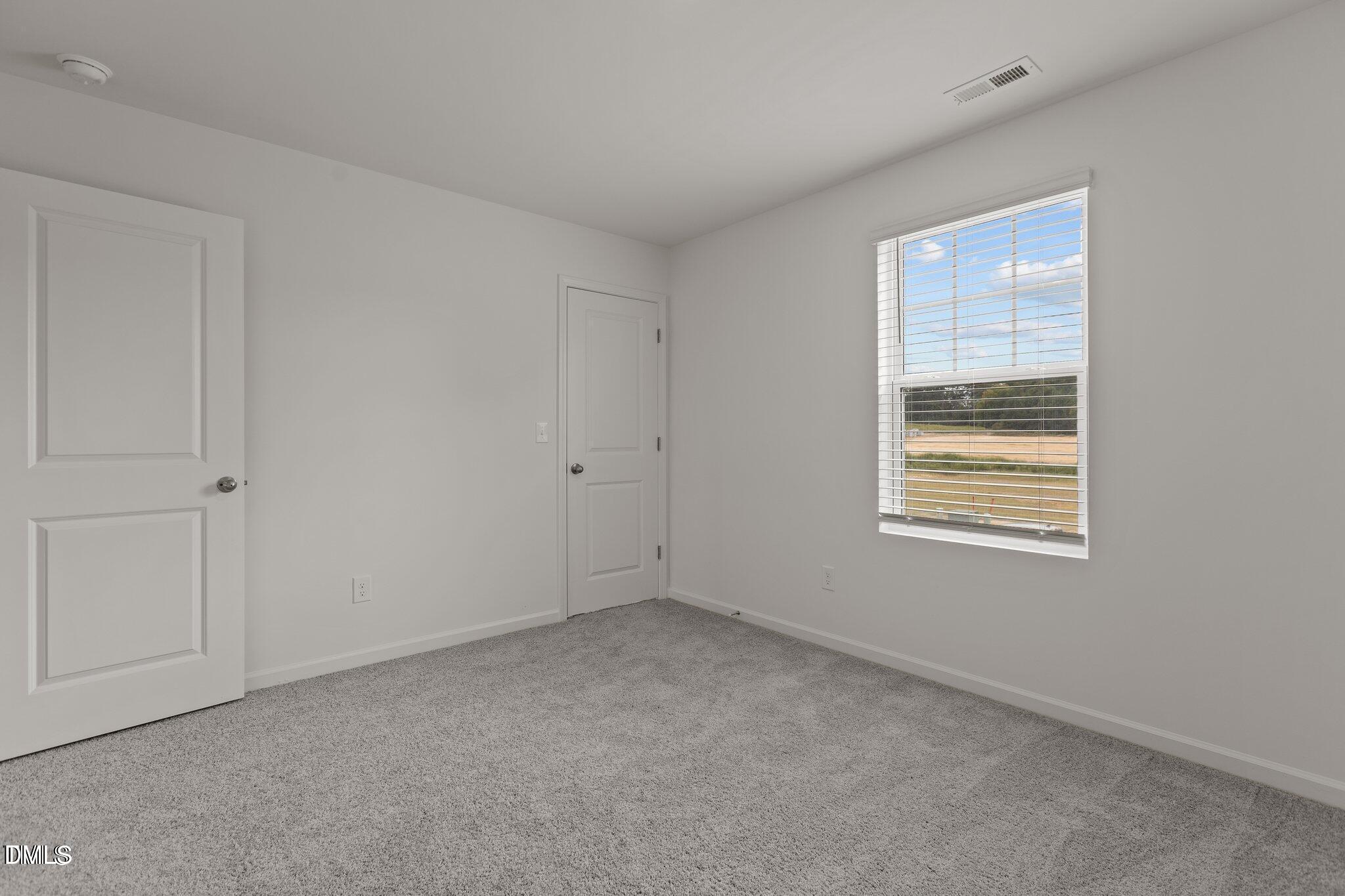 149 Bedstone Way Clayton, NC 27520 - Photo 18 of 22 a view of an empty room with a window