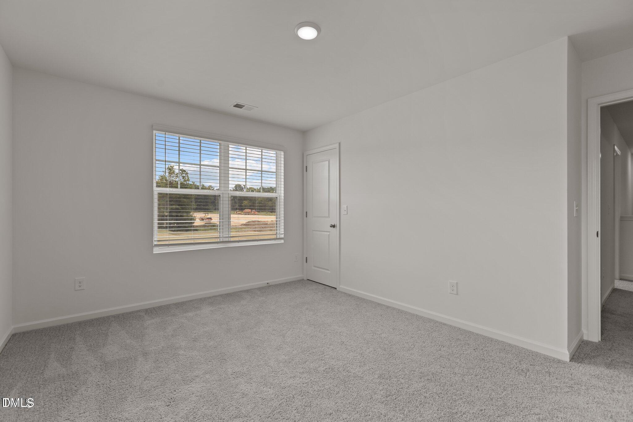 149 Bedstone Way Clayton, NC 27520 - Photo 20 of 22 a view of an empty room with a window