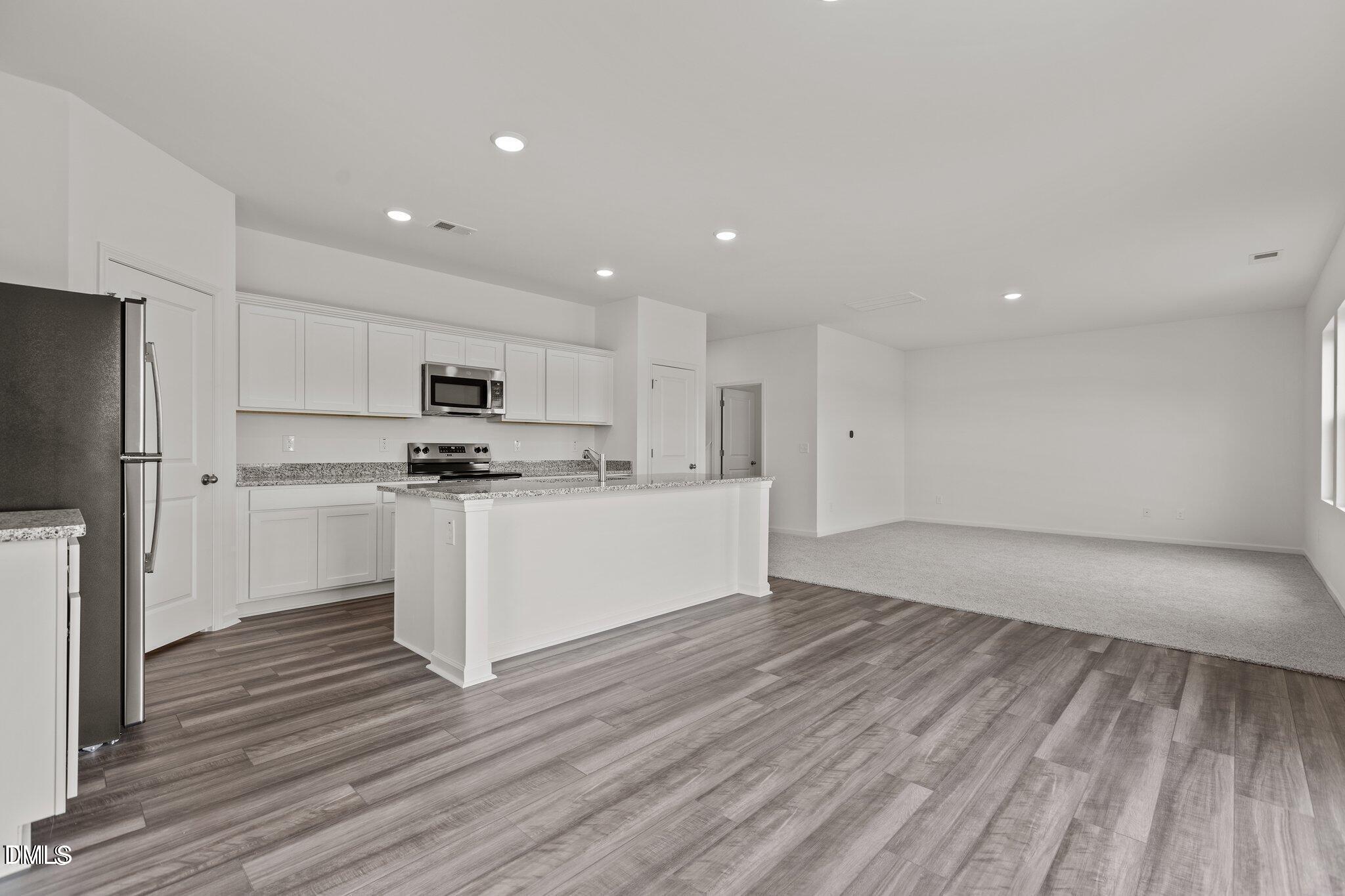 149 Bedstone Way Clayton, NC 27520 - Photo 5 of 22 a view of kitchen with wooden floor and electronic appliances