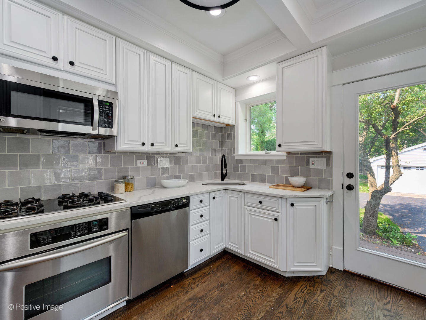 1137 Willow Road Winnetka, IL 60093 - Photo 12 of 31 a kitchen with cabinets stainless steel appliances a sink and window