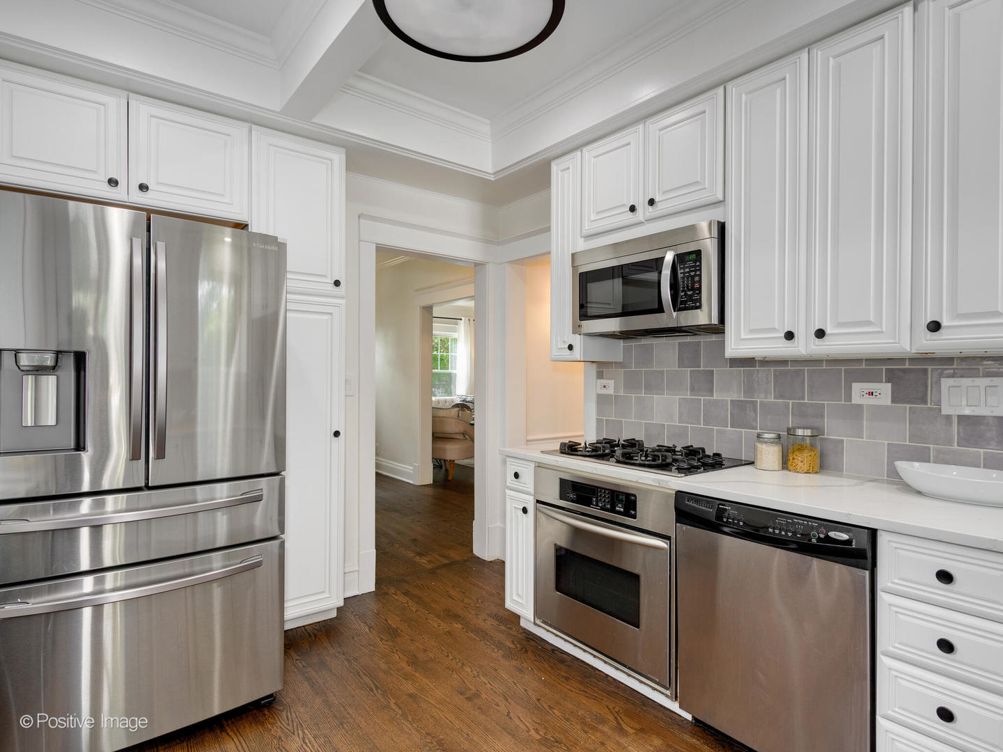 1137 Willow Road Winnetka, IL 60093 - Photo 13 of 31 a kitchen with cabinets stainless steel appliances and wooden floor
