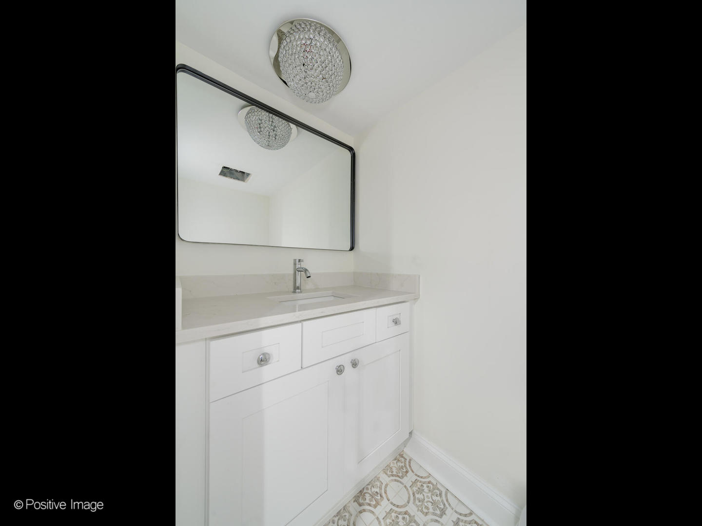 1137 Willow Road Winnetka, IL 60093 - Photo 25 of 31 a bathroom with a sink and mirror