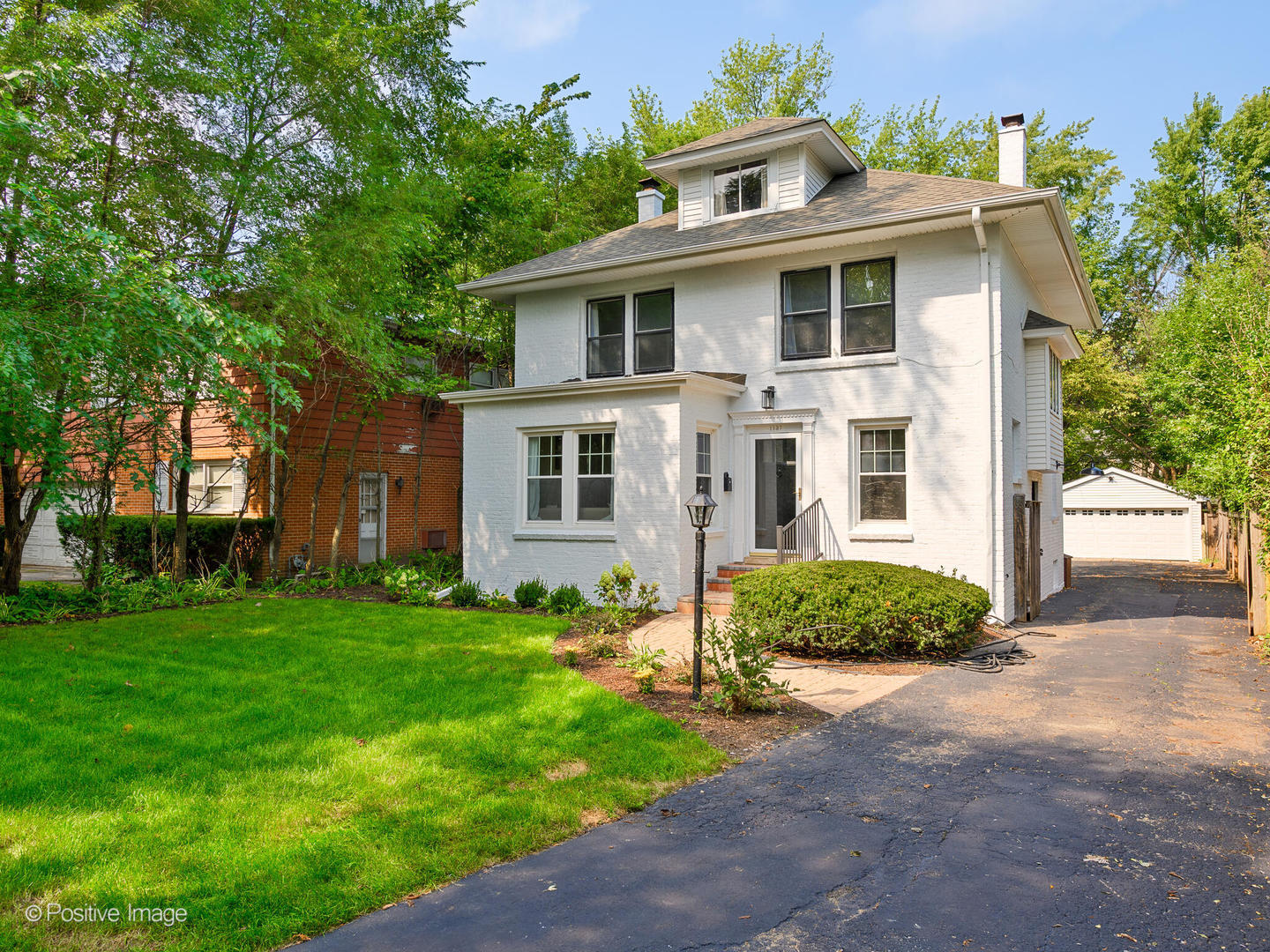 1137 Willow Road Winnetka, IL 60093 - Photo 31 of 31 a front view of a house with a garden