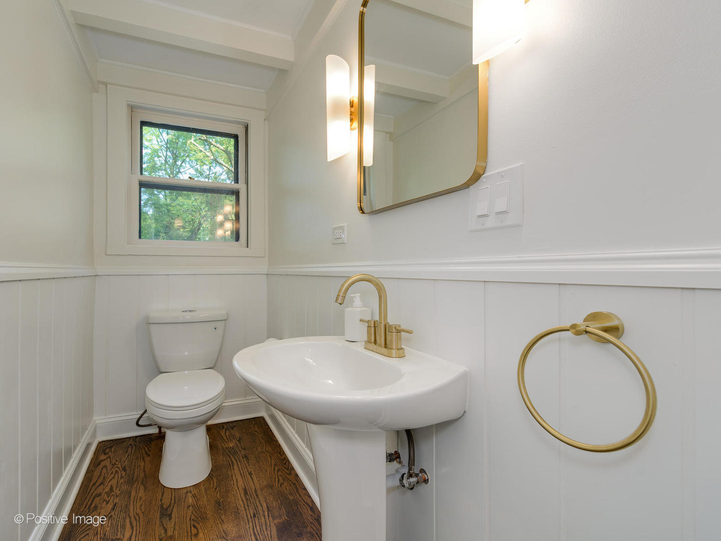 1137 Willow Road Winnetka, IL 60093 - Photo 10 of 31 a bathroom with a toilet a sink and a mirror