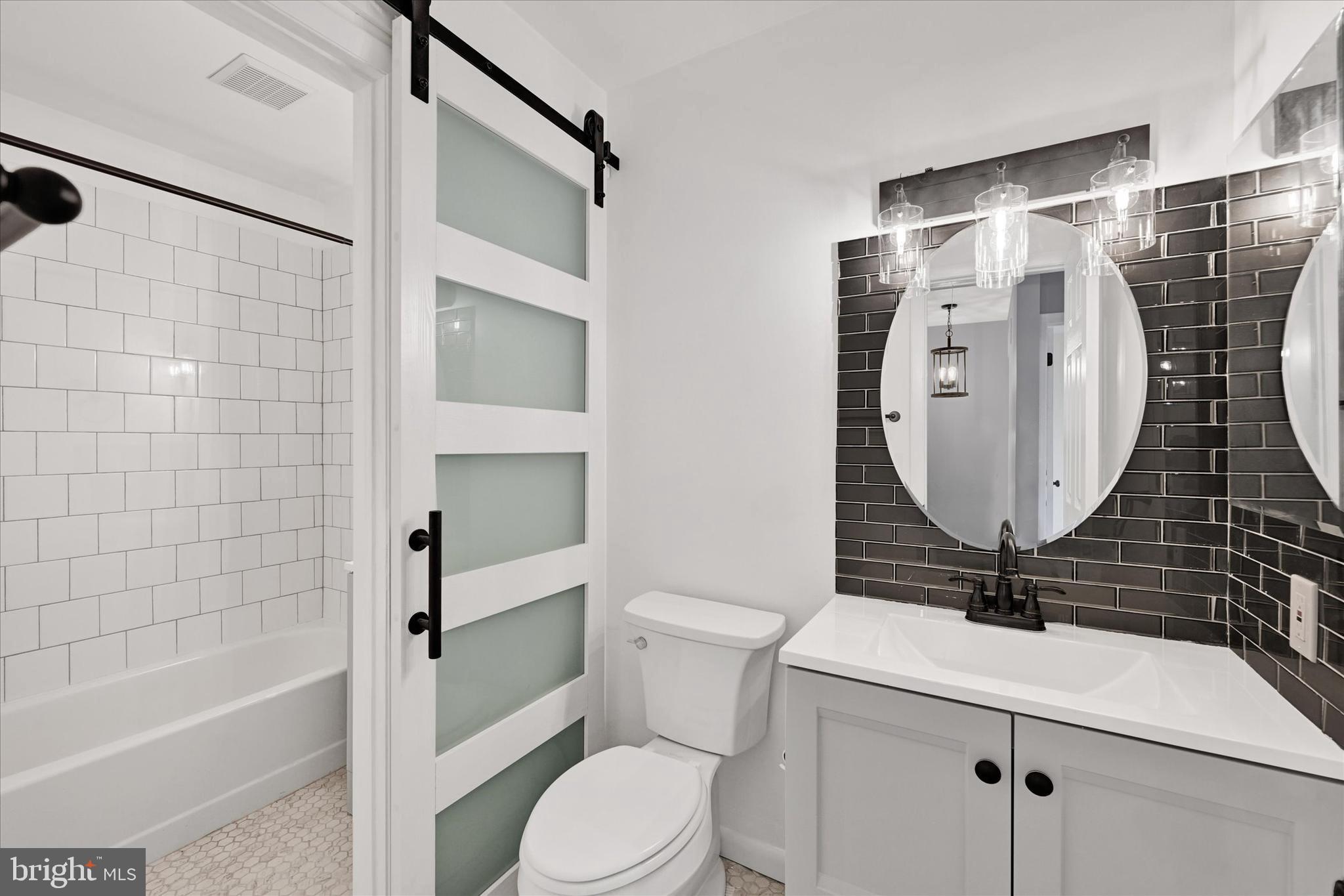 21 Allison Way Abingdon, MD 21009 - Photo 12 of 26 a bathroom with a sink toilet and shower