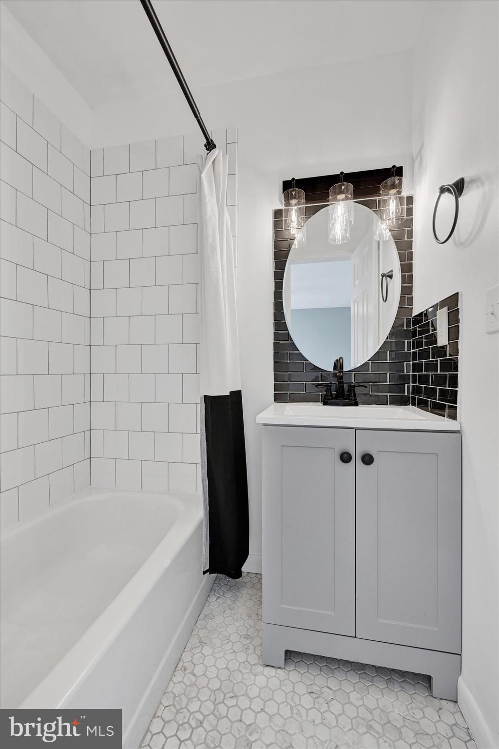 21 Allison Way Abingdon, MD 21009 - Photo 17 of 26 a bathroom with a tub sink and mirror