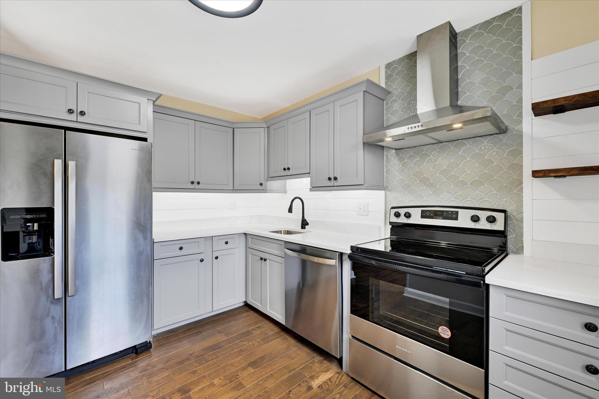 21 Allison Way Abingdon, MD 21009 - Photo 3 of 26 a kitchen with cabinets stainless steel appliances and wooden floor