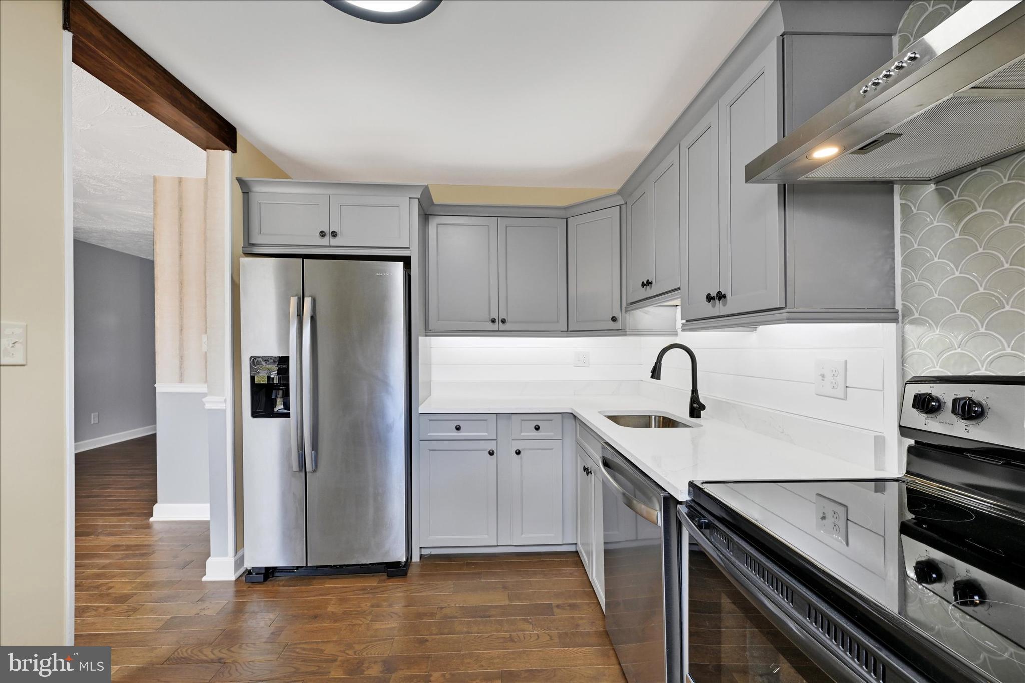 21 Allison Way Abingdon, MD 21009 - Photo 6 of 26 a kitchen with a sink a refrigerator and cabinets