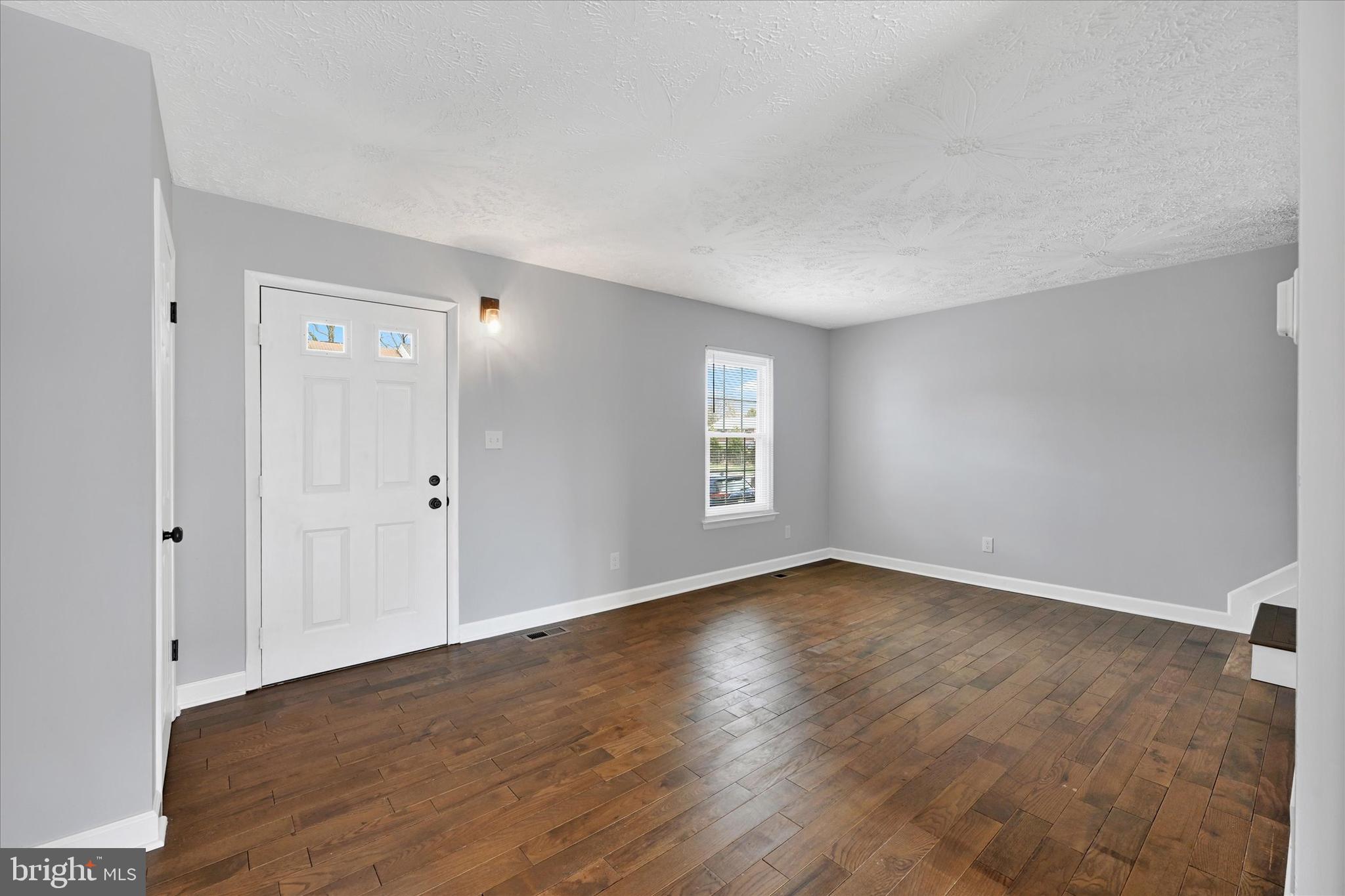 21 Allison Way Abingdon, MD 21009 - Photo 7 of 26 a view of an empty room with wooden floor and a window