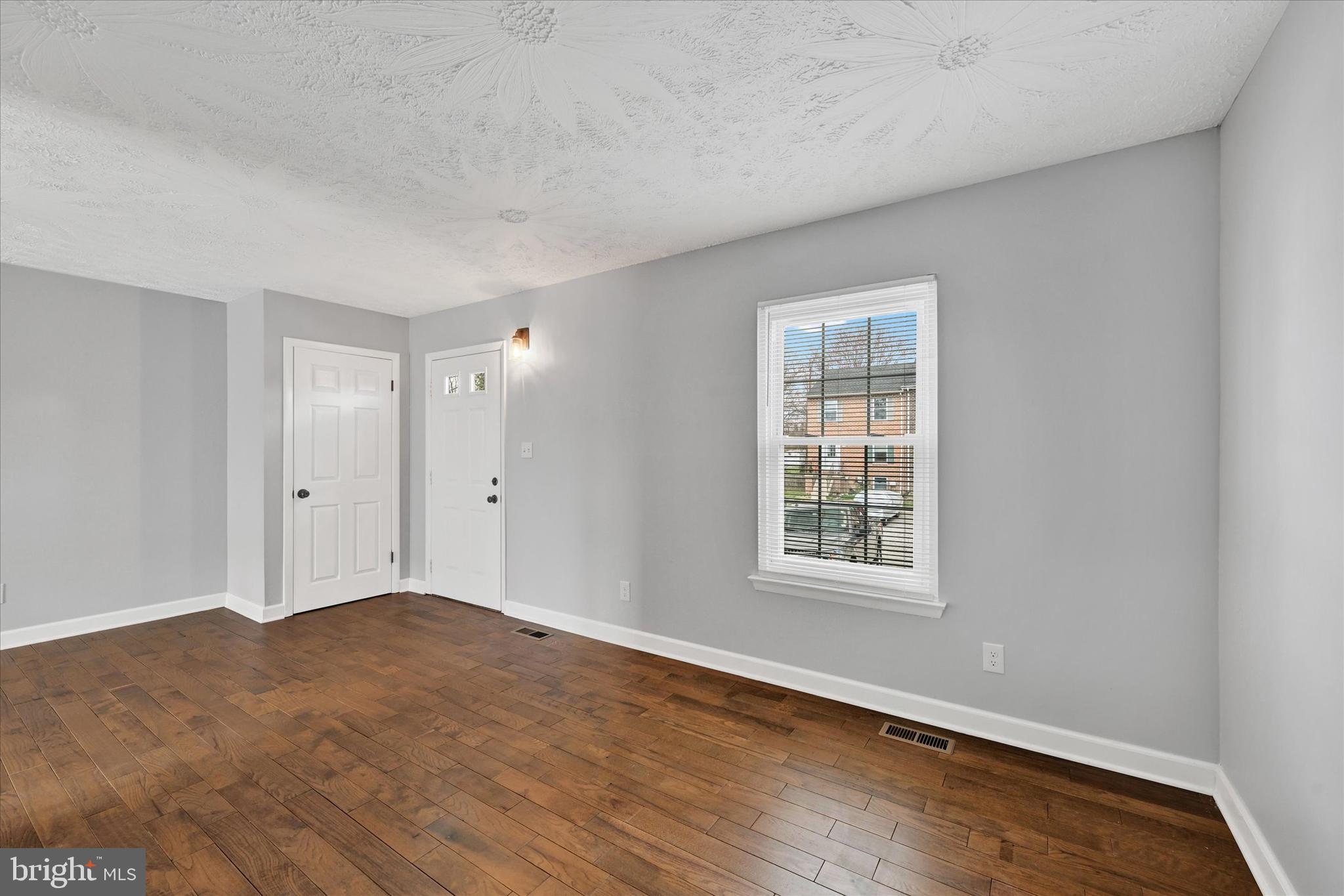 21 Allison Way Abingdon, MD 21009 - Photo 8 of 26 an empty room with wooden floor and windows