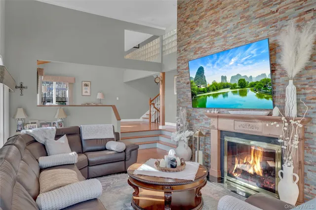 a living room with furniture a fireplace and a flat screen tv