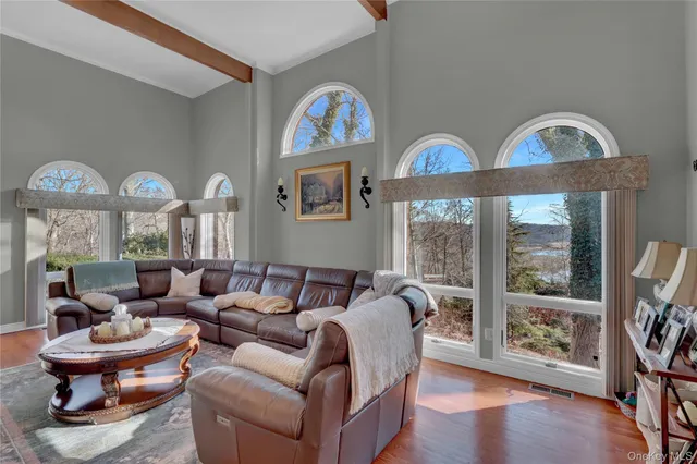 a living room with furniture a fireplace and a large window