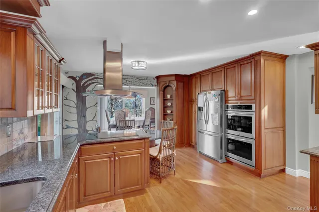 a kitchen with stainless steel appliances granite countertop a refrigerator and a stove