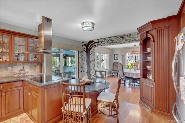 a kitchen with stainless steel appliances granite countertop a stove a sink dishwasher and cabinets with wooden floor