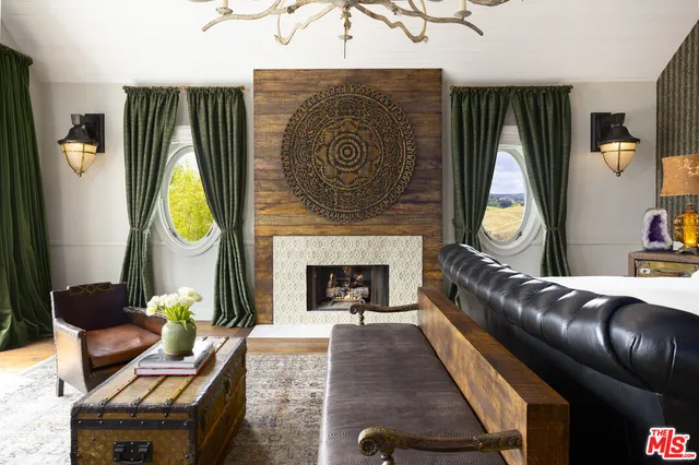 a bed room with furniture and a fireplace