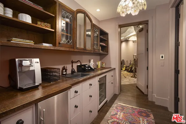 a view of a kitchen with pathway and an empty room