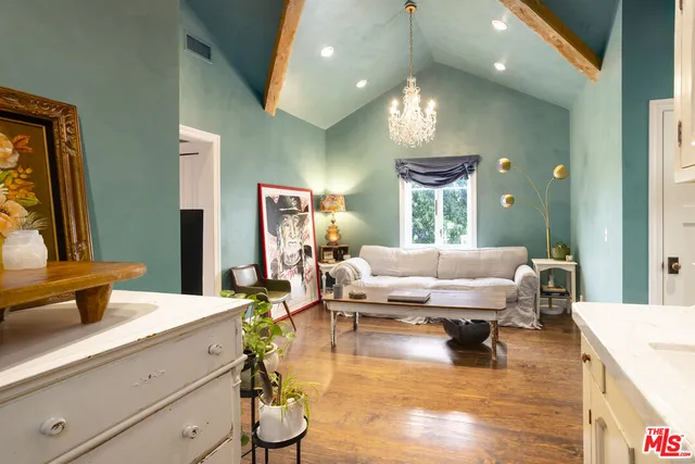 a view of a hallway to a livingroom with furniture