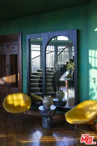 a living room with furniture fireplace and a large window