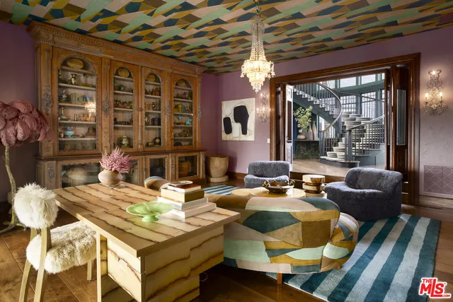 a living room with a couch wooden floor and a fireplace