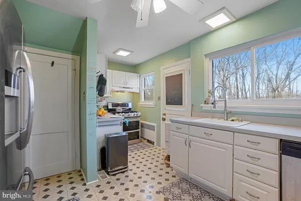 a kitchen with a sink refrigerator and microwave