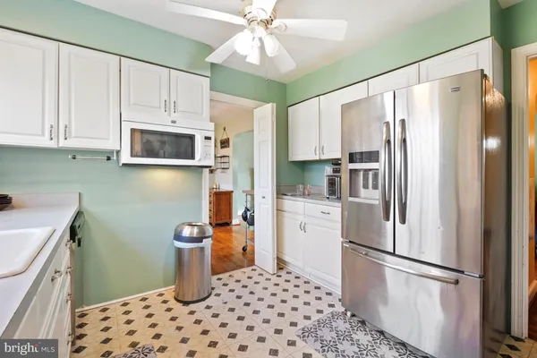 a kitchen with stainless steel appliances a refrigerator sink and microwave