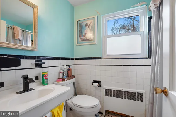 a bathroom with a toilet a sink and a window