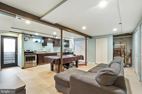 a living room with furniture and a kitchen view