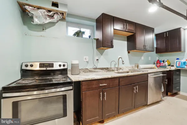 a kitchen with stainless steel appliances granite countertop a stove and a sink