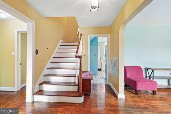 a view of a room with wooden floor and lounge chair