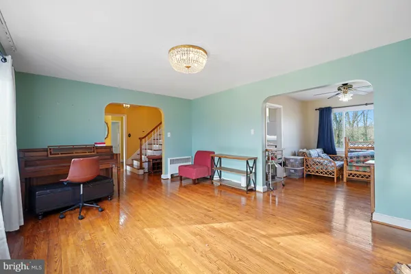 a living room with furniture and a chandelier