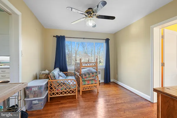 a bedroom with furniture and wooden floor